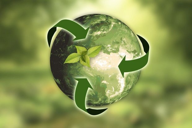 A globe with green recycling arrows symbolizing the circular economy action plan in chemical distribution and universal recycling technologies.